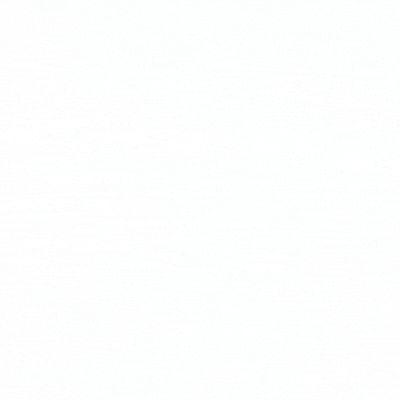 Man at desk analyzes video footage on multiple monitors in a dark room.